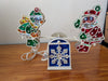 Santa & Angel Seesaw Light from Unknown (Possibly H.C. Company or a similar brand) - 1980s-1990s Holiday Decor (Plastic, Holographic Foil, Wiring Christmas Light Decoration, Christmas, Holiday, Retro, Kitsch, White, Red, Green, Blue, Yellow)